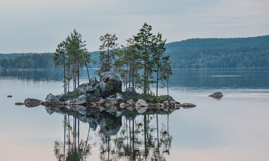 lago grande con una isla de árboles en el centro